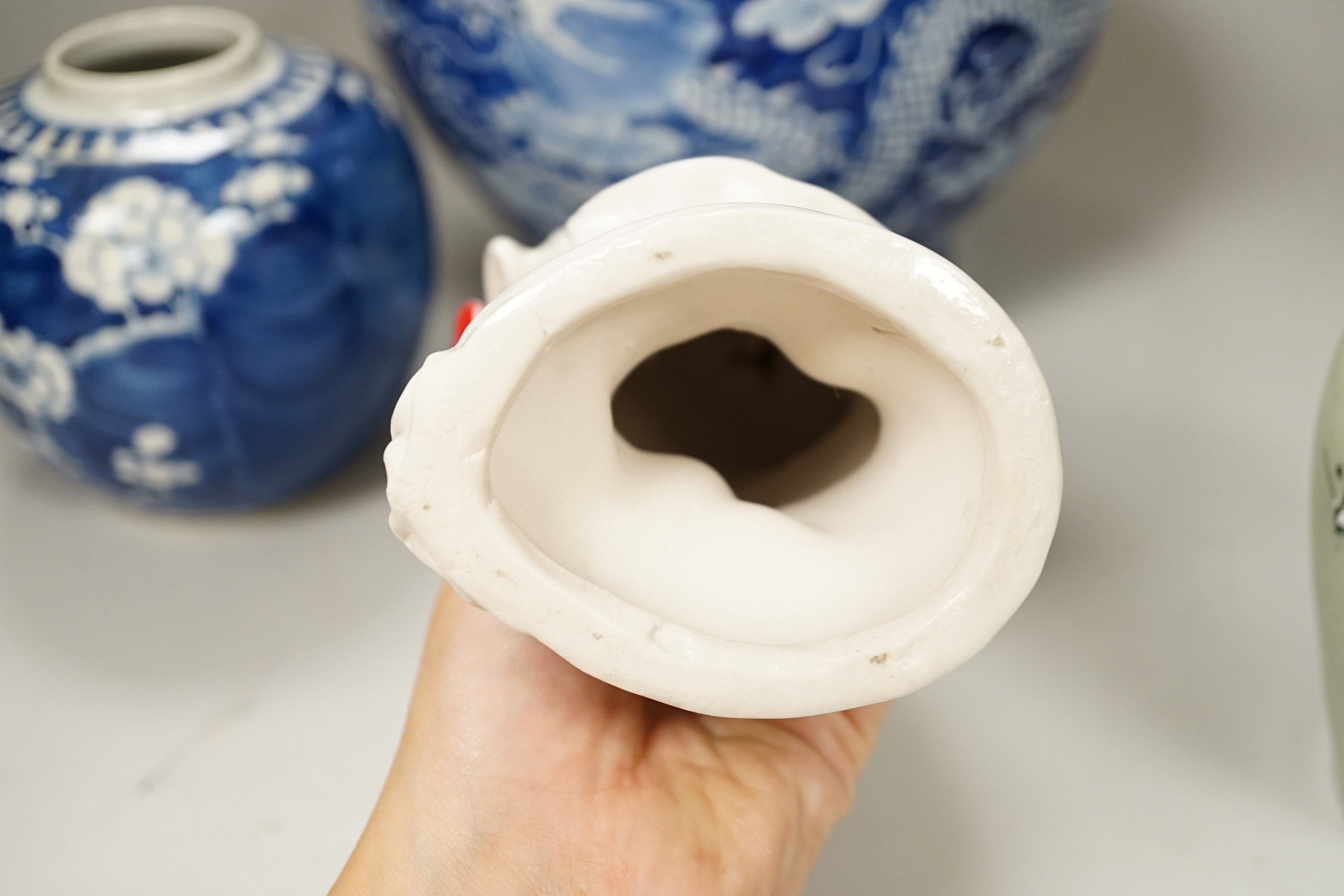 A group of Chinese ceramics including a celadon glazed vase, blue and white jar, white glazed figure and a jardiniere